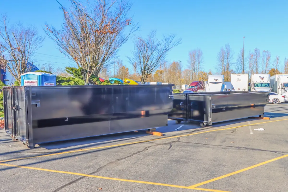 Professional dumpster rental service with roll-off container on residential driveway in Crowley